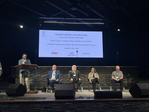 Conference panelists seated on the stage for session about accessibility in publishing
