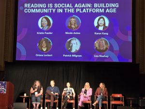 stage with 5 speakers seating in front of a screen for a session titled Reading is Social Again